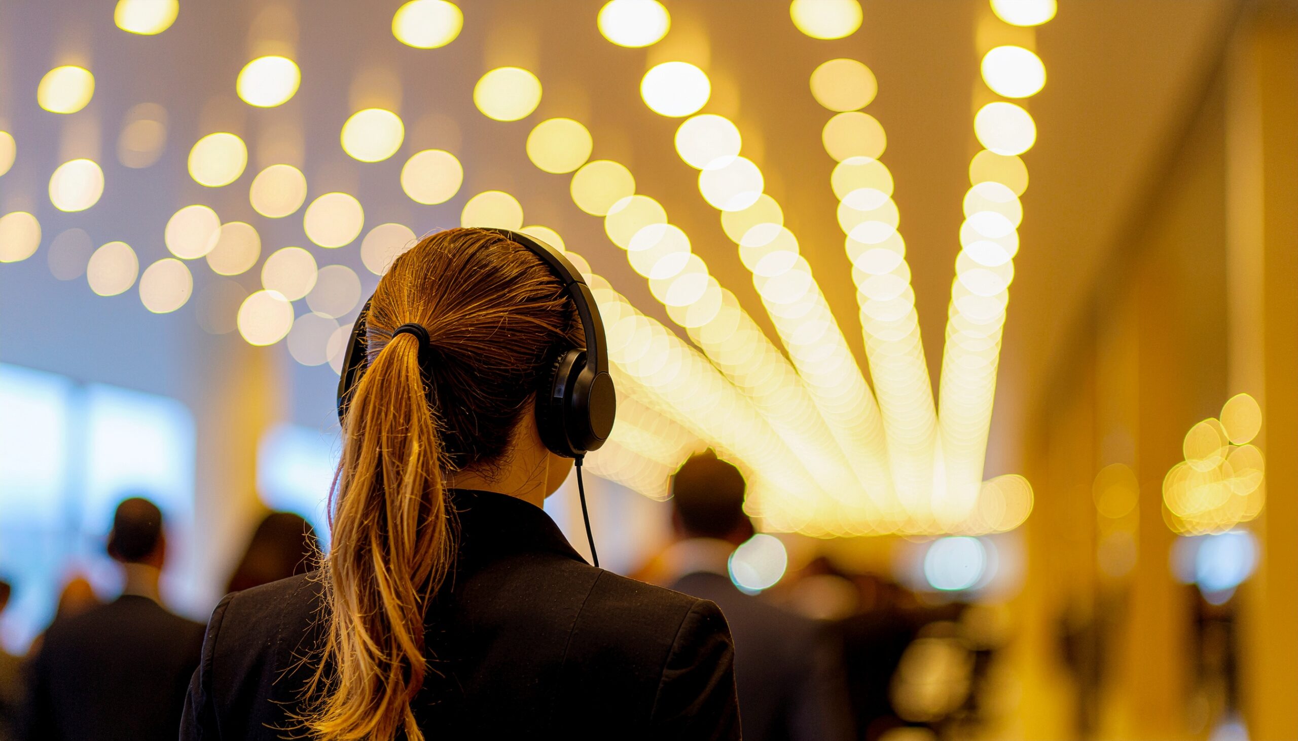 consultancy services person facing away with headphones in an office environment