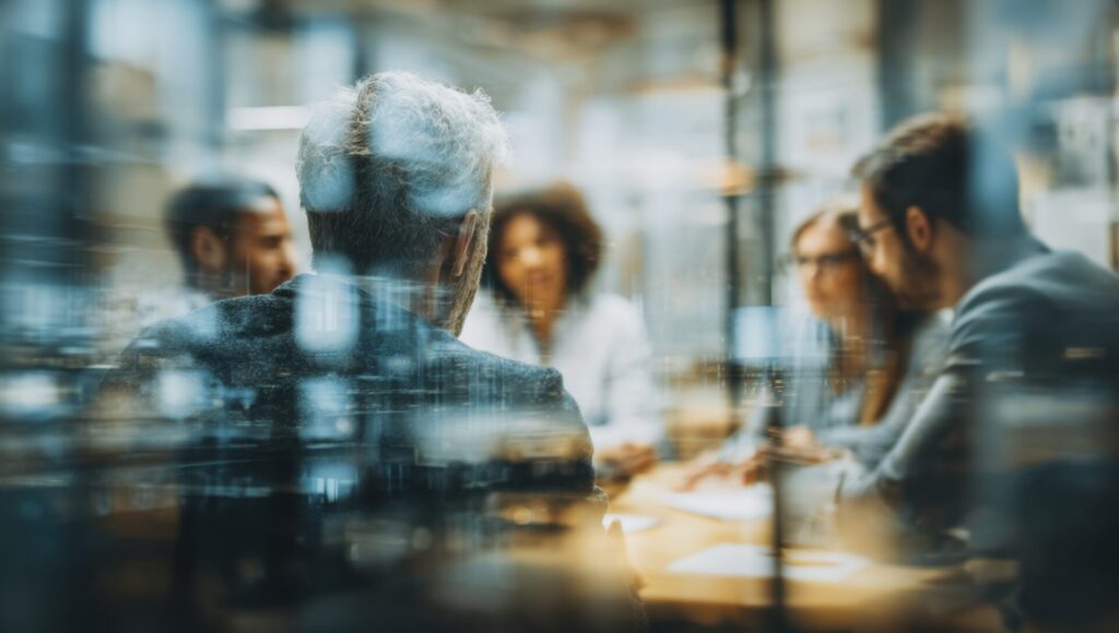 Diverse team collaborating in a modern office setting fostering innovation and strategic planning for future success with a focus on leadership.